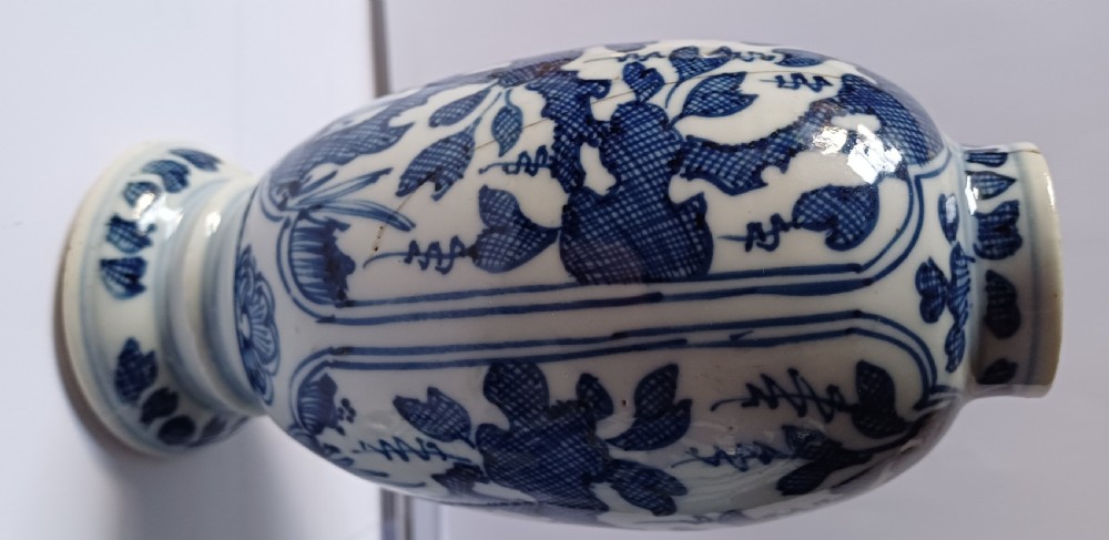 A pair of antique Chinese Kangxi period ovoid porcelain jars with fitted lids, decorated with hand-painted cobalt blue floral motifs on a white background. View XV