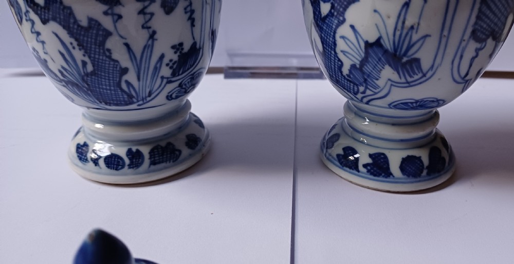A pair of antique Chinese Kangxi period ovoid porcelain jars with fitted lids, decorated with hand-painted cobalt blue floral motifs on a white background. View XXI