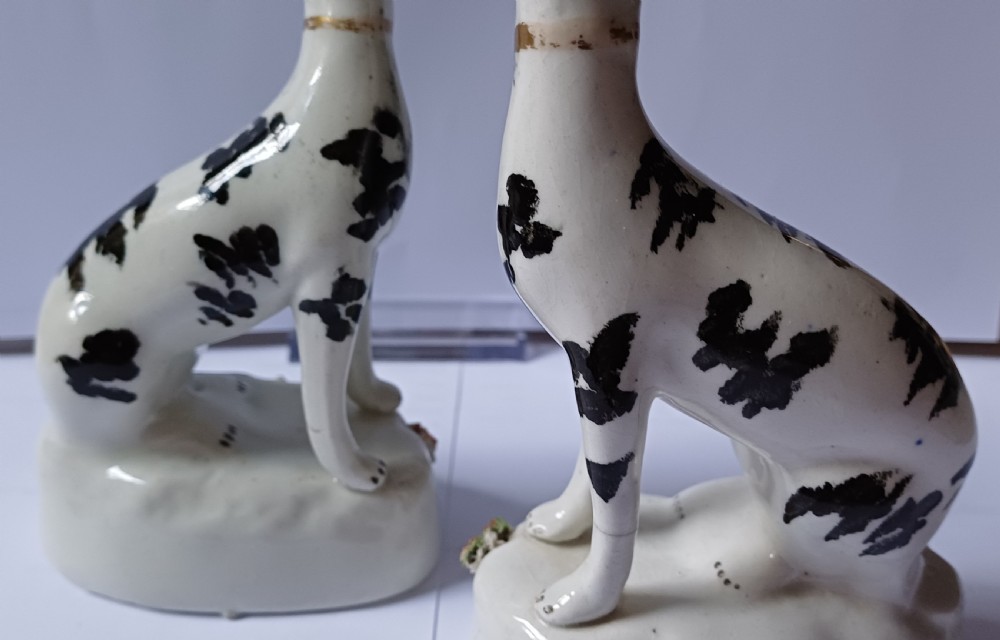 A Staffordshire rare pair on small black & white seated hounds dating circa 1865 View XIV
