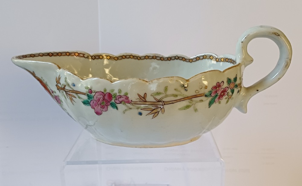 An 18th-century Chinese export famille rose porcelain sauce boat decorated with a hand-painted crest, coat of arms, and floral motifs. View IV