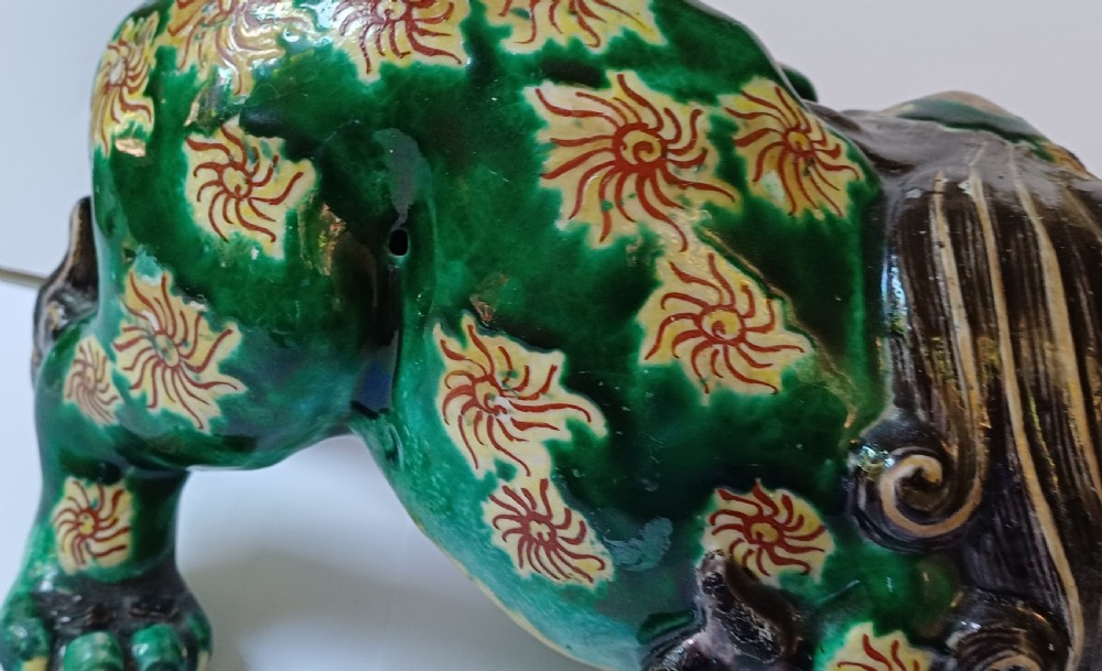 A Japanese Kutani glazed porcelain Shishi lion featuring a vibrant emerald green body decorated with gold floral motifs and a dark scrolling mane. View VIII