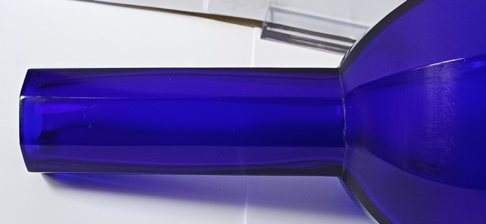 A cobalt blue glass bottle vase featuring an octagonal faceted globular body and a tall matching octagonal neck. View VI