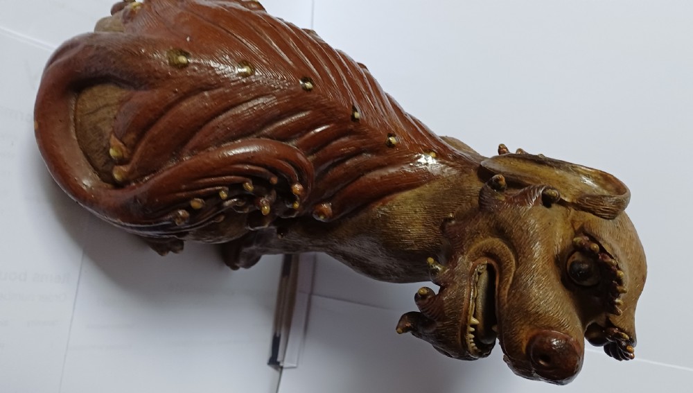 A pair of antique brown glazed ceramic Chinese Shiwan Buddhistic lion dogs depicted sitting upright with open mouths and detailed carved fur. View IX