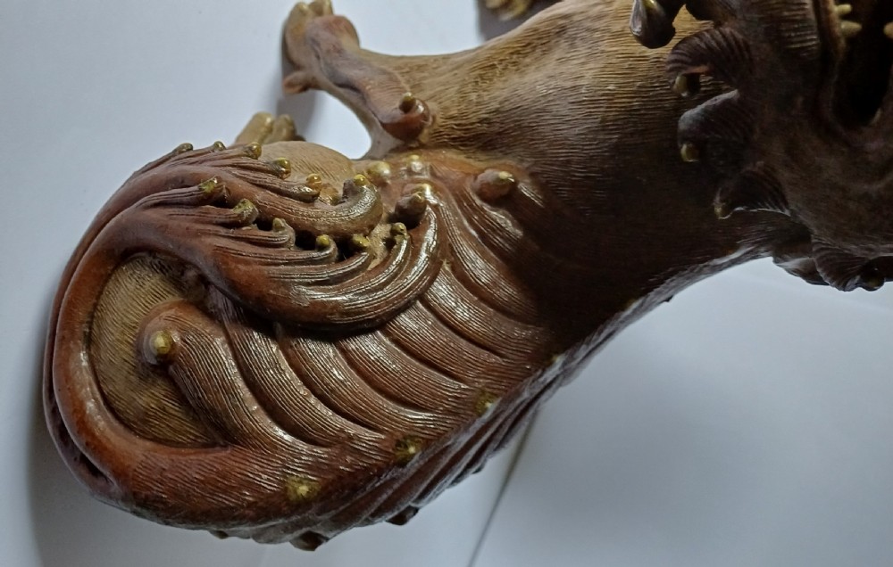 A pair of antique brown glazed ceramic Chinese Shiwan Buddhistic lion dogs depicted sitting upright with open mouths and detailed carved fur. View XV