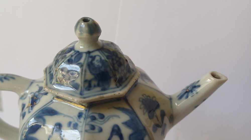 An octagonal Chinese porcelain teapot decorated with cobalt blue figures in landscapes and gold leaf highlights. View X