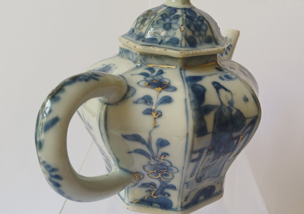 An octagonal Chinese porcelain teapot decorated with cobalt blue figures in landscapes and gold leaf highlights. View XI