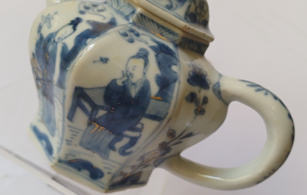 An octagonal Chinese porcelain teapot decorated with cobalt blue figures in landscapes and gold leaf highlights. View XV