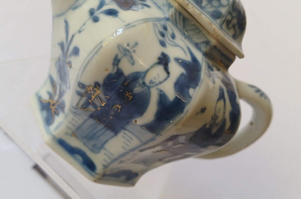 An octagonal Chinese porcelain teapot decorated with cobalt blue figures in landscapes and gold leaf highlights. View XVI
