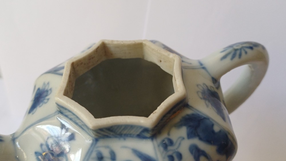 An octagonal Chinese porcelain teapot decorated with cobalt blue figures in landscapes and gold leaf highlights. View XVII