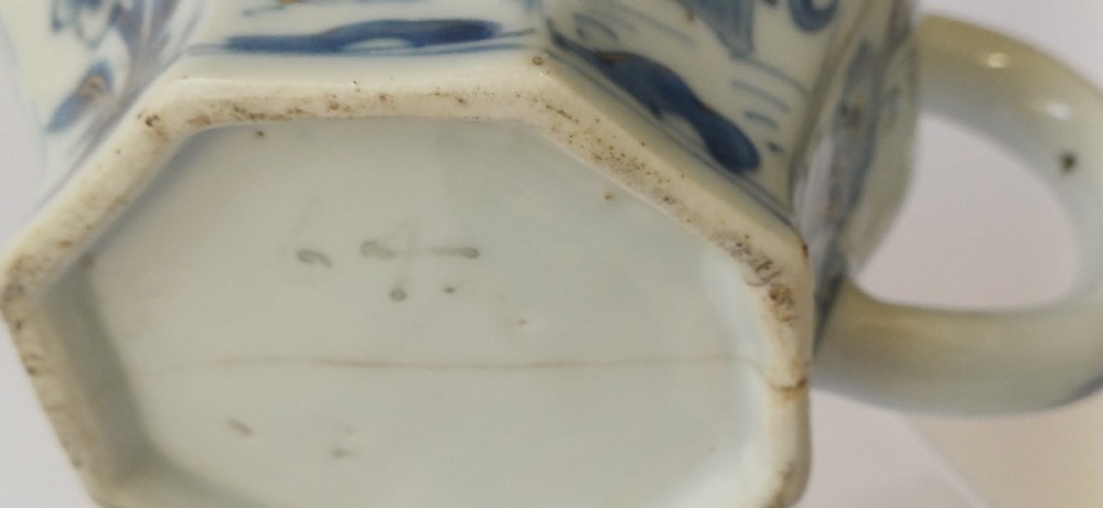 An octagonal Chinese porcelain teapot decorated with cobalt blue figures in landscapes and gold leaf highlights. View XXI