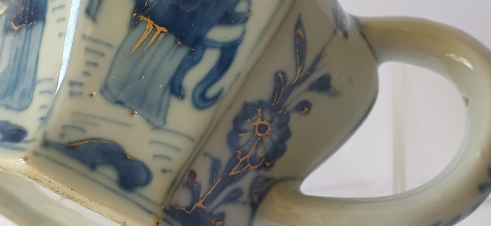 An octagonal Chinese porcelain teapot decorated with cobalt blue figures in landscapes and gold leaf highlights. View XXII