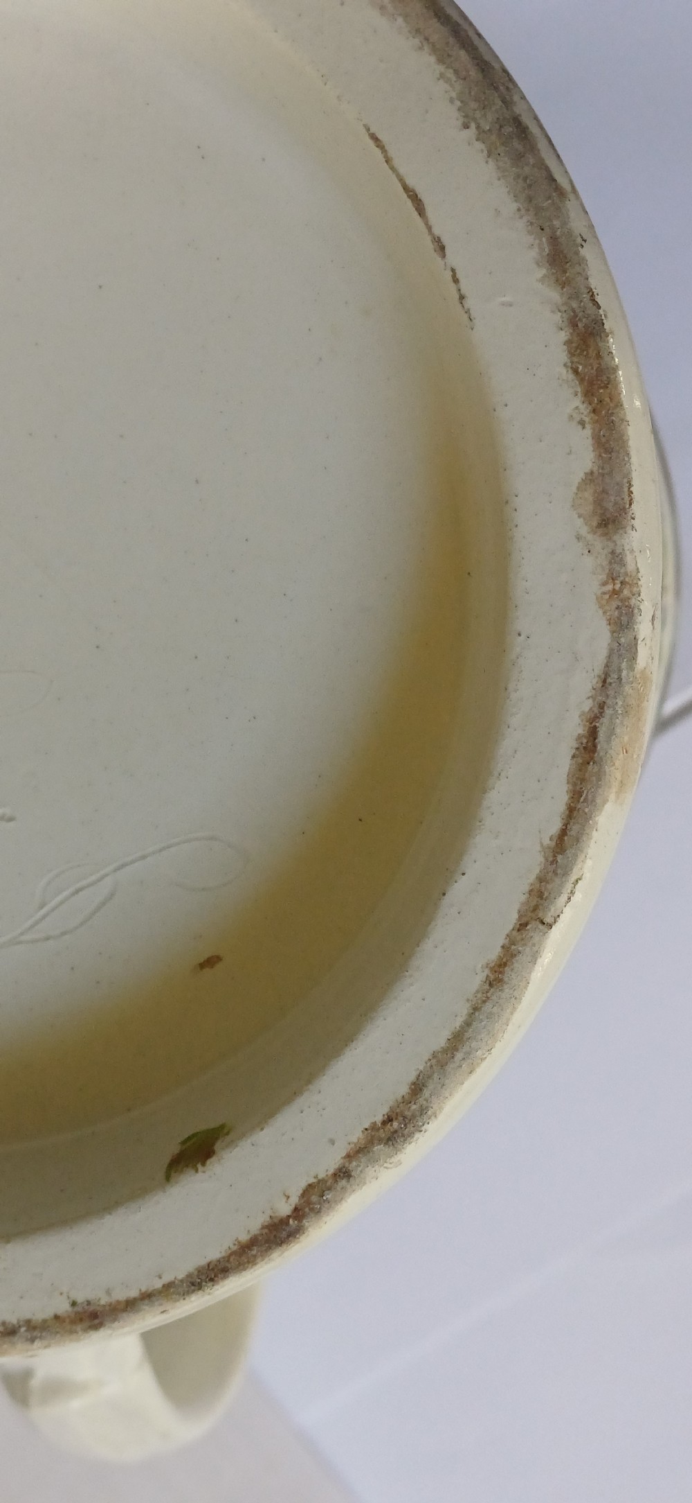 A Georgian pearlware ceramic mug featuring polychrome relief-moulded floral garlands, basketweave bands, gilt accents, and the word WARRANTED. View XIII