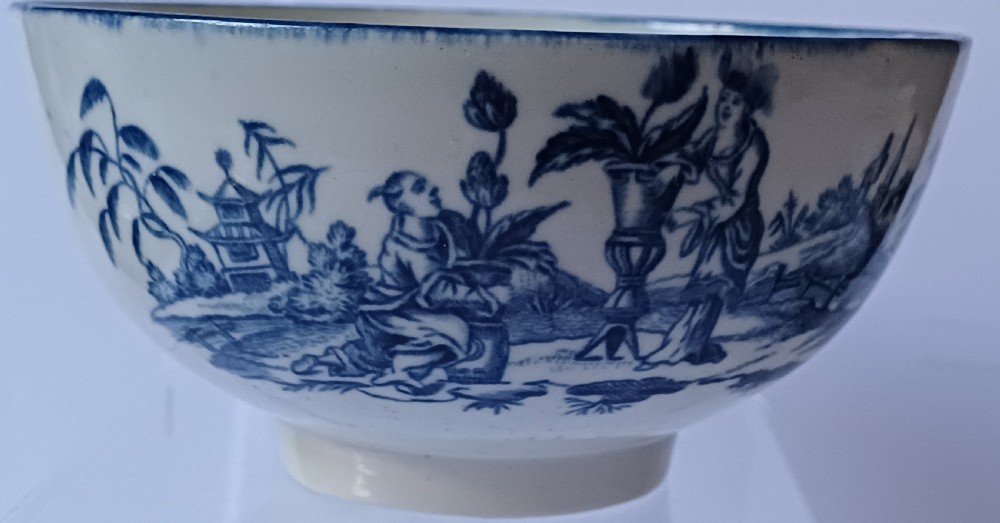 An eighteenth-century circular soft-paste porcelain bowl decorated with a hand-painted chinoiserie scene in underglaze blue on a cream background. View XIII
