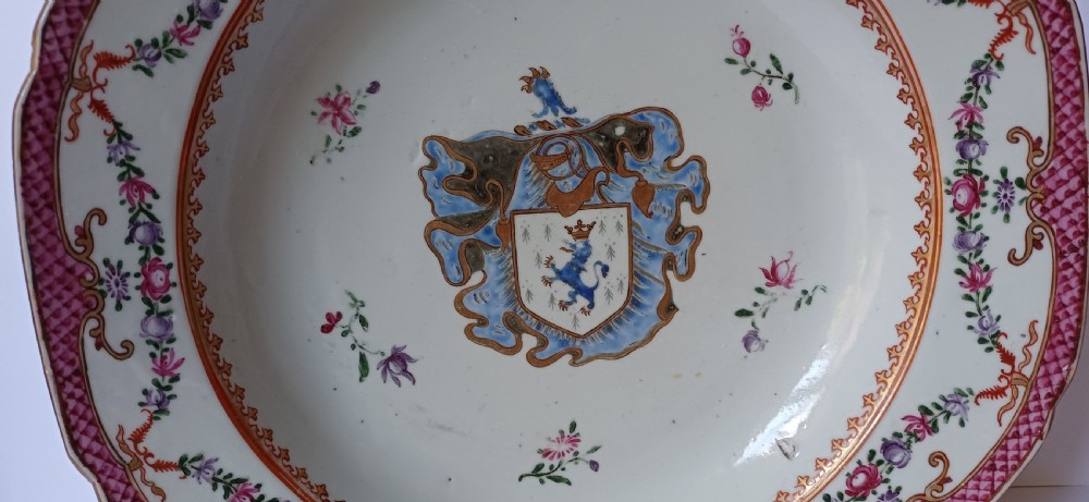 An 18th-century octagonal Chinese export porcelain soup plate featuring a central heraldic coat of arms surrounded by floral sprays and a pink diaper-patterned rim. View III