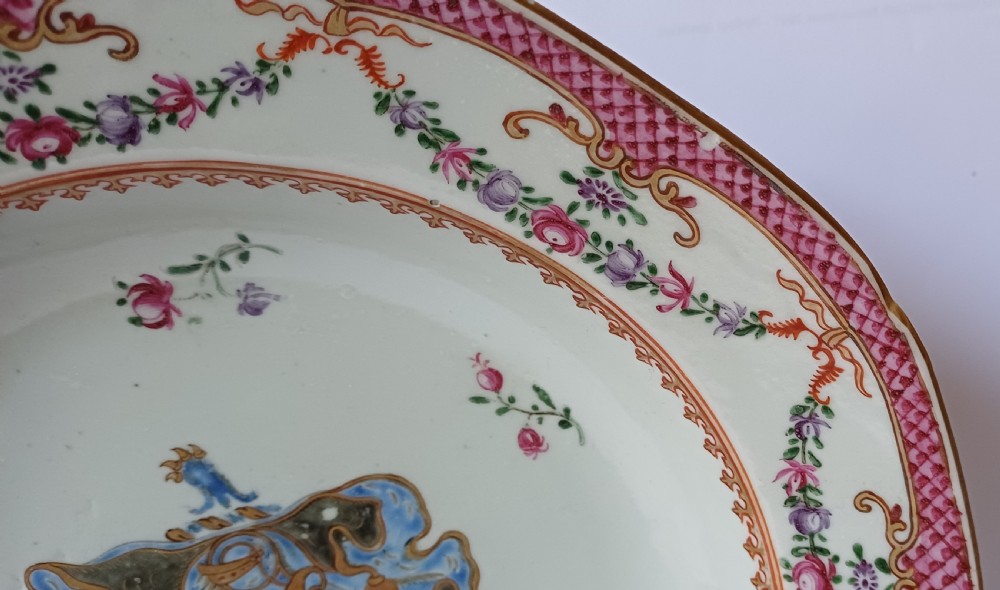 An 18th-century octagonal Chinese export porcelain soup plate featuring a central heraldic coat of arms surrounded by floral sprays and a pink diaper-patterned rim. View IV