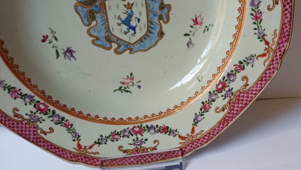 An 18th-century octagonal Chinese export porcelain soup plate featuring a central heraldic coat of arms surrounded by floral sprays and a pink diaper-patterned rim. View V