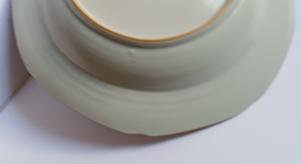 An 18th-century octagonal Chinese export porcelain soup plate featuring a central heraldic coat of arms surrounded by floral sprays and a pink diaper-patterned rim. View VIII