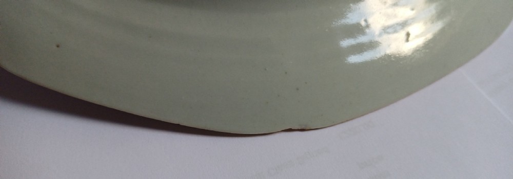 An 18th-century octagonal Chinese export porcelain soup plate featuring a central heraldic coat of arms surrounded by floral sprays and a pink diaper-patterned rim. View XII