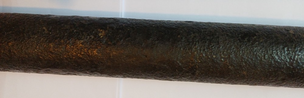 An antique brass single-draw naval telescope wrapped in textured black leather with official markings engraved near the eyepiece. View V