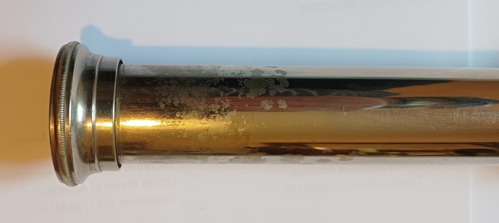 An antique brass single-draw naval telescope wrapped in textured black leather with official markings engraved near the eyepiece. View XIII
