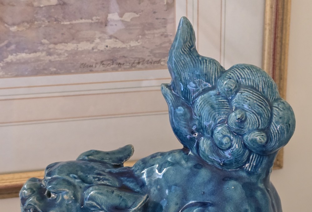 A Japanese glazed ceramic shishi guardian lion rendered in a rich turquoise blue glaze with a raised curling tail. View XI
