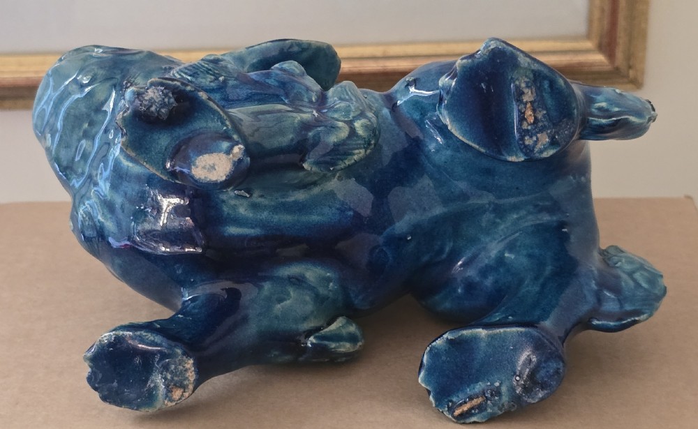 A Japanese glazed ceramic shishi guardian lion rendered in a rich turquoise blue glaze with a raised curling tail. View XV