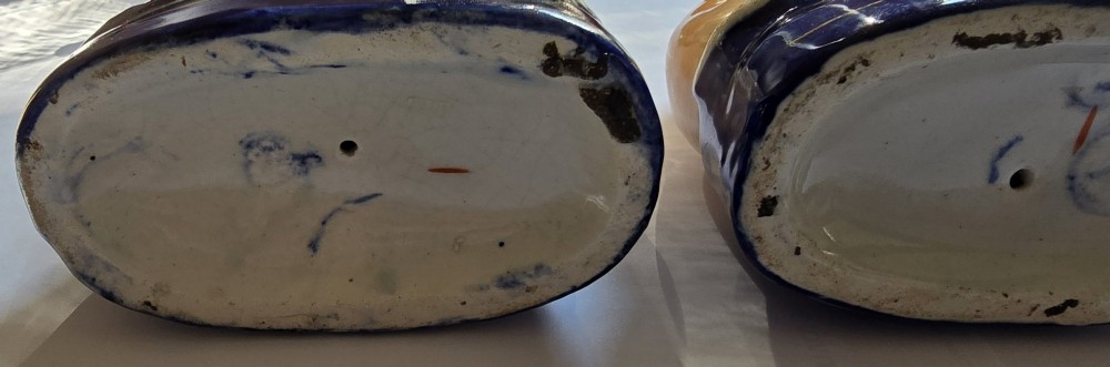 A pair of Victorian Staffordshire earthenware figurines depicting seated buff-coloured whippet dogs positioned on cobalt blue bases. View X
