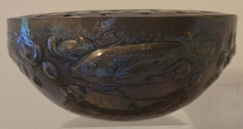 A hand-hammered dark copper rose bowl featuring embossed fish motifs and a pierced top lid. View III