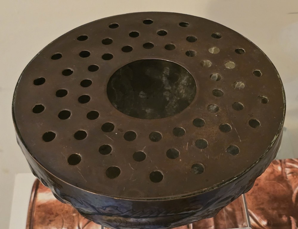 A hand-hammered dark copper rose bowl featuring embossed fish motifs and a pierced top lid. View IV