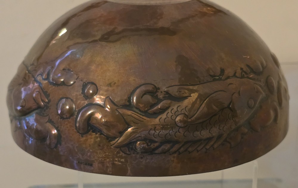 A hand-hammered dark copper rose bowl featuring embossed fish motifs and a pierced top lid. View IX