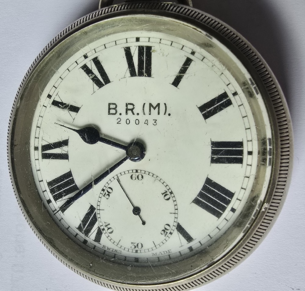 A British Rail Midland Region open-face pocket watch featuring a white dial with Roman numerals, spade hands, and a subsidiary seconds subdial.