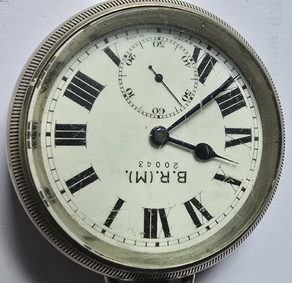 A British Rail Midland Region open-face pocket watch featuring a white dial with Roman numerals, spade hands, and a subsidiary seconds subdial. View III