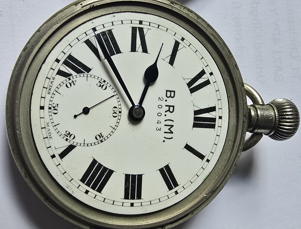 A British Rail Midland Region open-face pocket watch featuring a white dial with Roman numerals, spade hands, and a subsidiary seconds subdial. View V