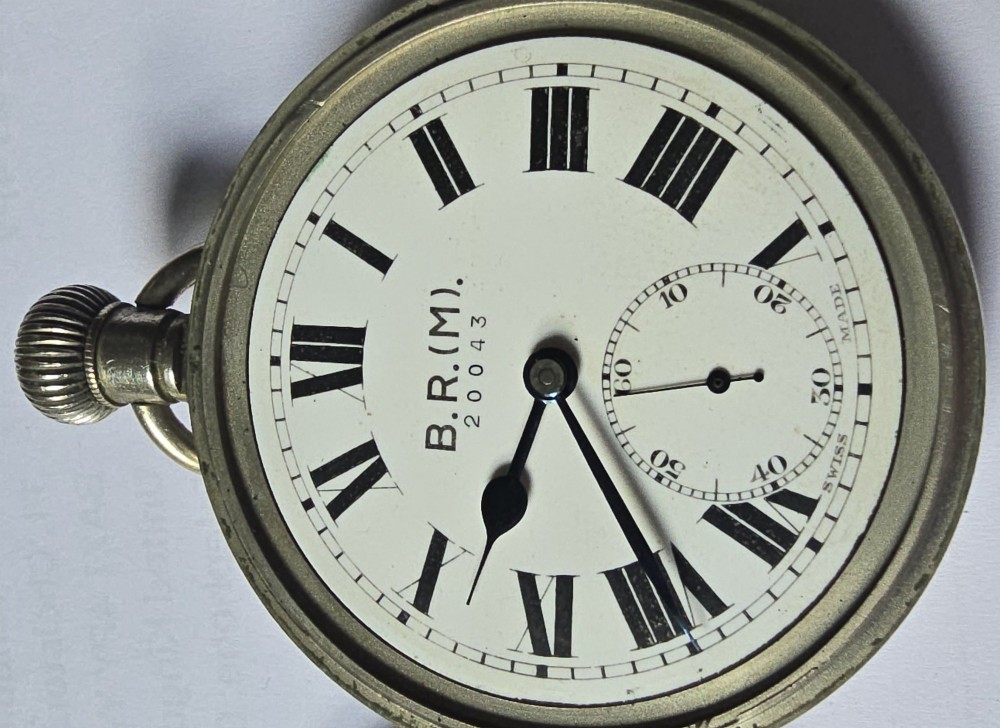 A British Rail Midland Region open-face pocket watch featuring a white dial with Roman numerals, spade hands, and a subsidiary seconds subdial. View VI