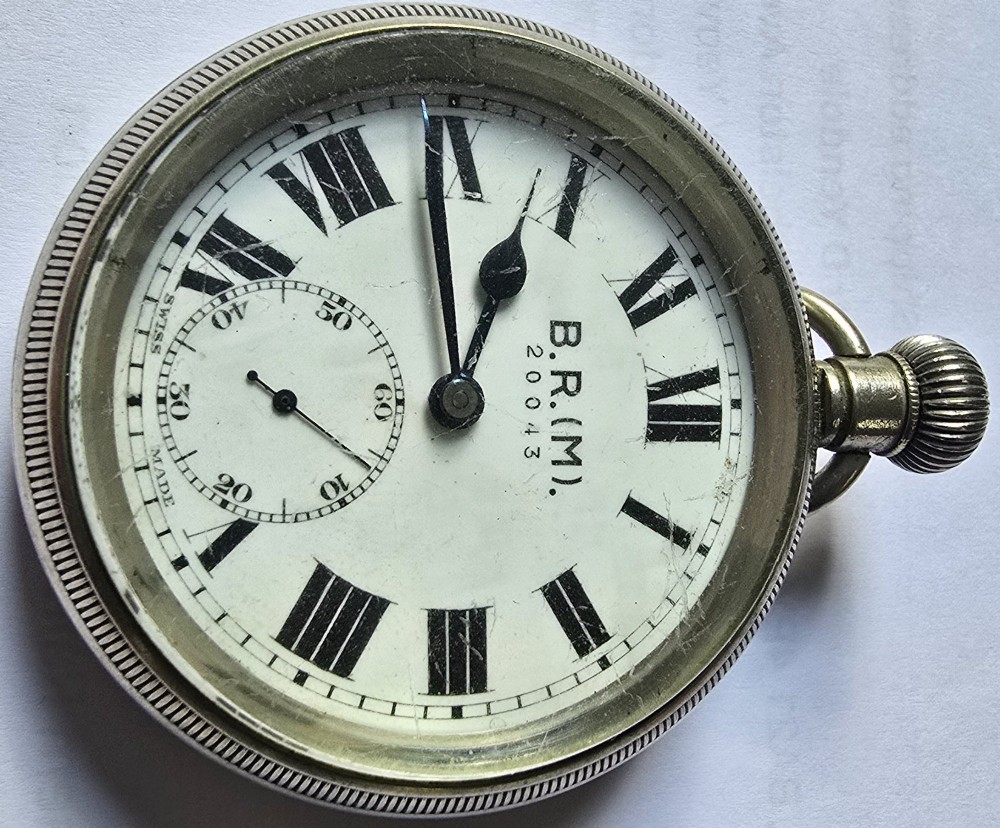 A British Rail Midland Region open-face pocket watch featuring a white dial with Roman numerals, spade hands, and a subsidiary seconds subdial. View XII