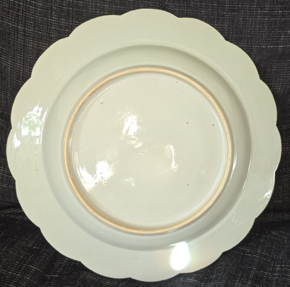 An antique circular off-white porcelain dish with a scalloped rim, hand-painted with pink lotus blossoms, foliage, a crane, and a waterfowl. View VIII