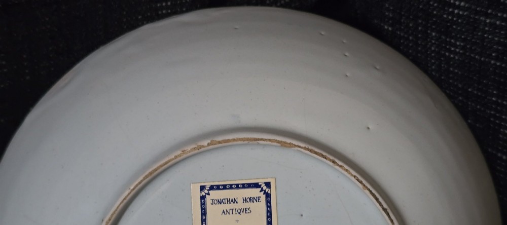 An eighteenth-century circular English delftware saucer dish painted with a cobalt blue dragon motif on a white tin glaze. View VII