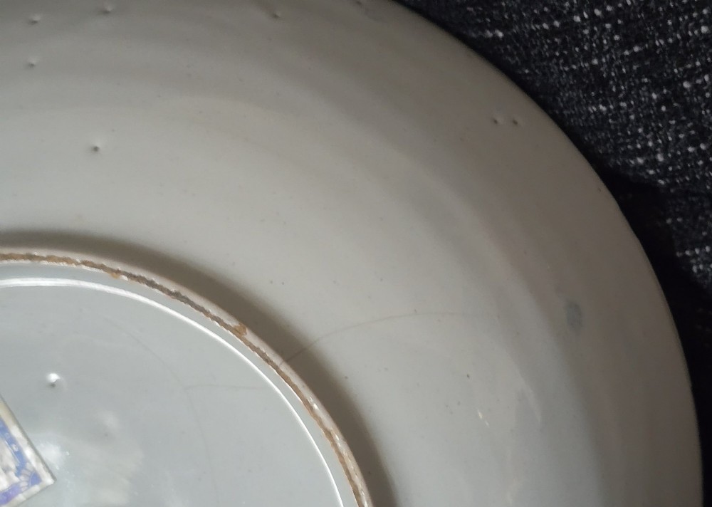 An eighteenth-century circular English delftware saucer dish painted with a cobalt blue dragon motif on a white tin glaze. View IX