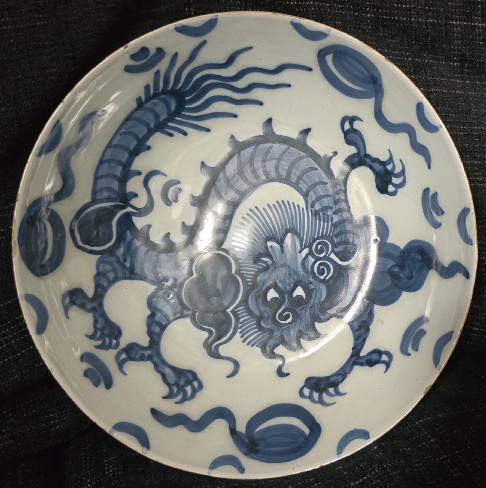 An eighteenth-century circular English delftware saucer dish painted with a cobalt blue dragon motif on a white tin glaze. View XII