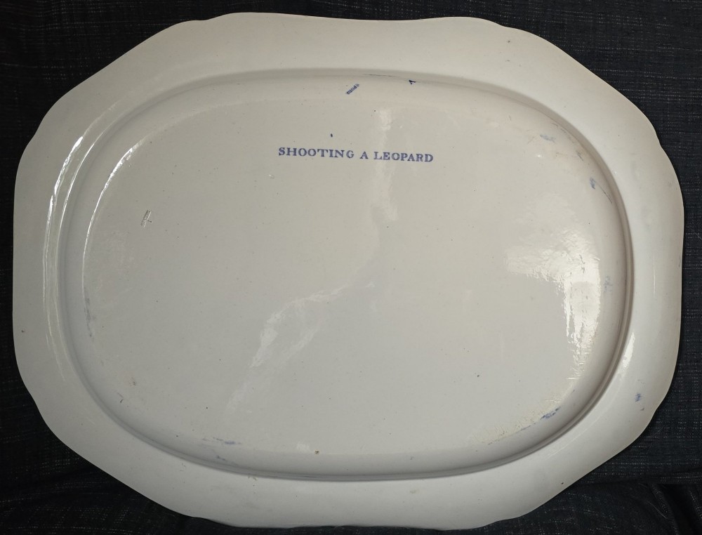 An oval blue and white underglaze transfer-printed earthenware meat platter depicting a landscape with hunters on elephants and hounds pursuing a leopard. View II