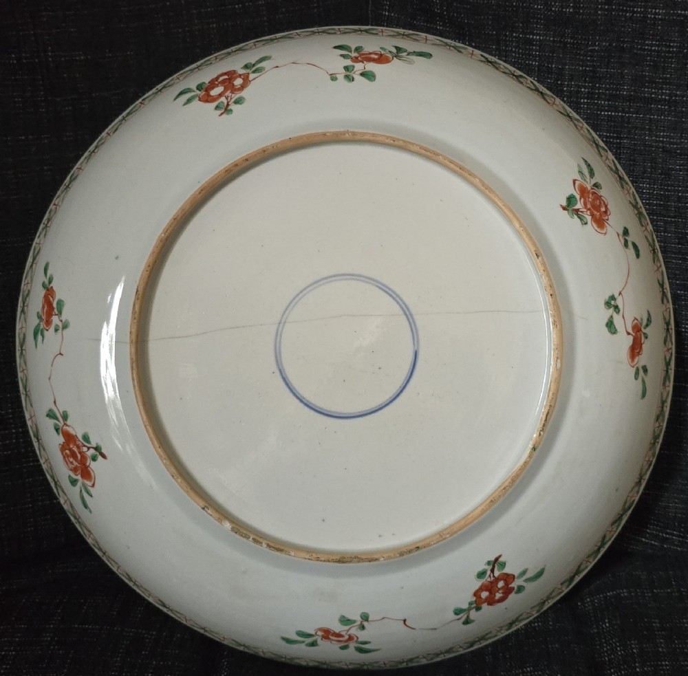 A circular Chinese famille verte porcelain dish featuring hand-painted peony blossoms, foliage, a bird in flight, and a decorative patterned border. View VII