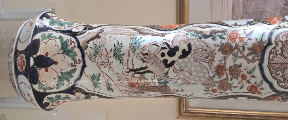 A tall Japanese Imari porcelain trumpet vase featuring hand-painted designs of horses, floral panels, and geometric borders in blue, iron red, and enamels. View II