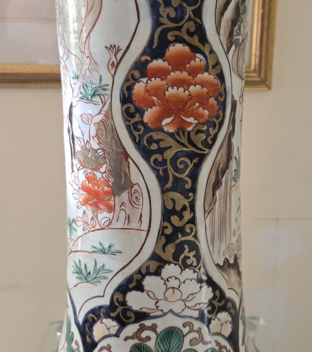 A tall Japanese Imari porcelain trumpet vase featuring hand-painted designs of horses, floral panels, and geometric borders in blue, iron red, and enamels. View XI