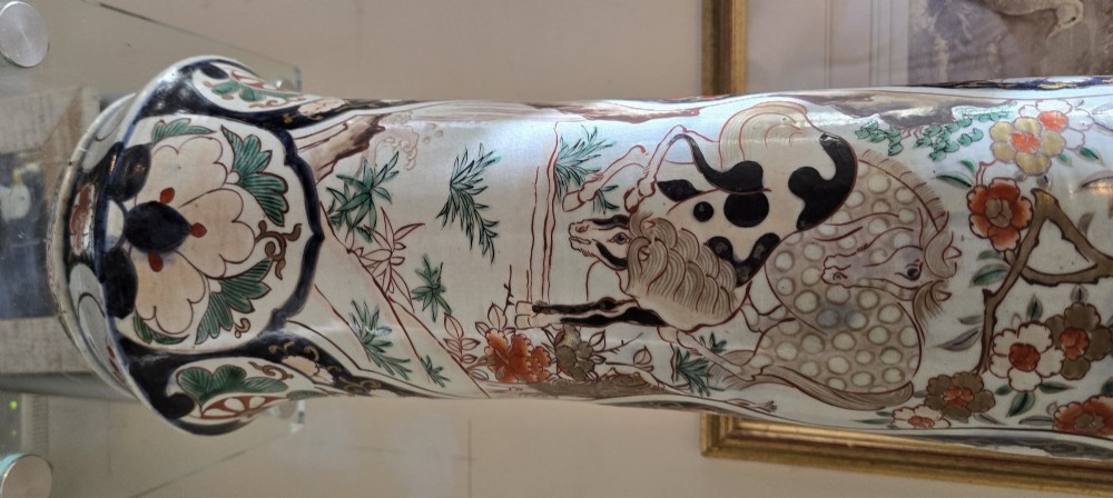A tall Japanese Imari porcelain trumpet vase featuring hand-painted designs of horses, floral panels, and geometric borders in blue, iron red, and enamels. View XV
