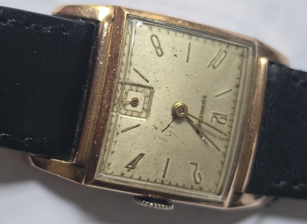 A vintage Longines rectangular wristwatch featuring a rose gold-filled case, patinated dial with Arabic numerals, sub-seconds register, and a black leather strap. View XIII