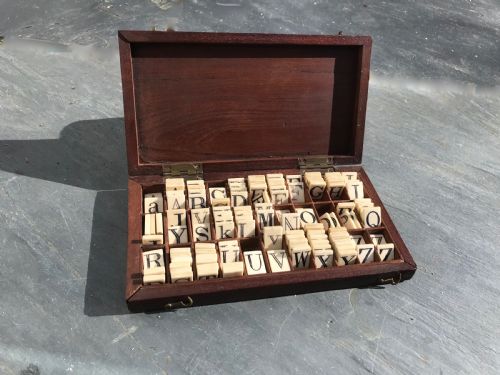 A 19th Century Mahogany Boxed Set of Bone Alphabet Tiles