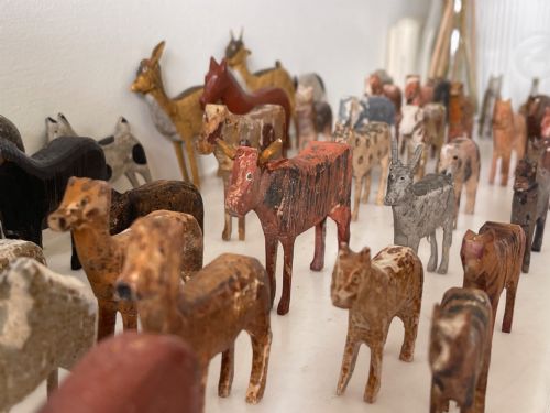 fig 2. A hand-painted 19th-century wooden Noahs ark toy with a pitched roof and painted windows, accompanied by carved wooden figures.