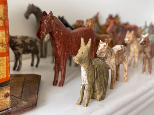 fig 3. A hand-painted 19th-century wooden Noahs ark toy with a pitched roof and painted windows, accompanied by carved wooden figures.