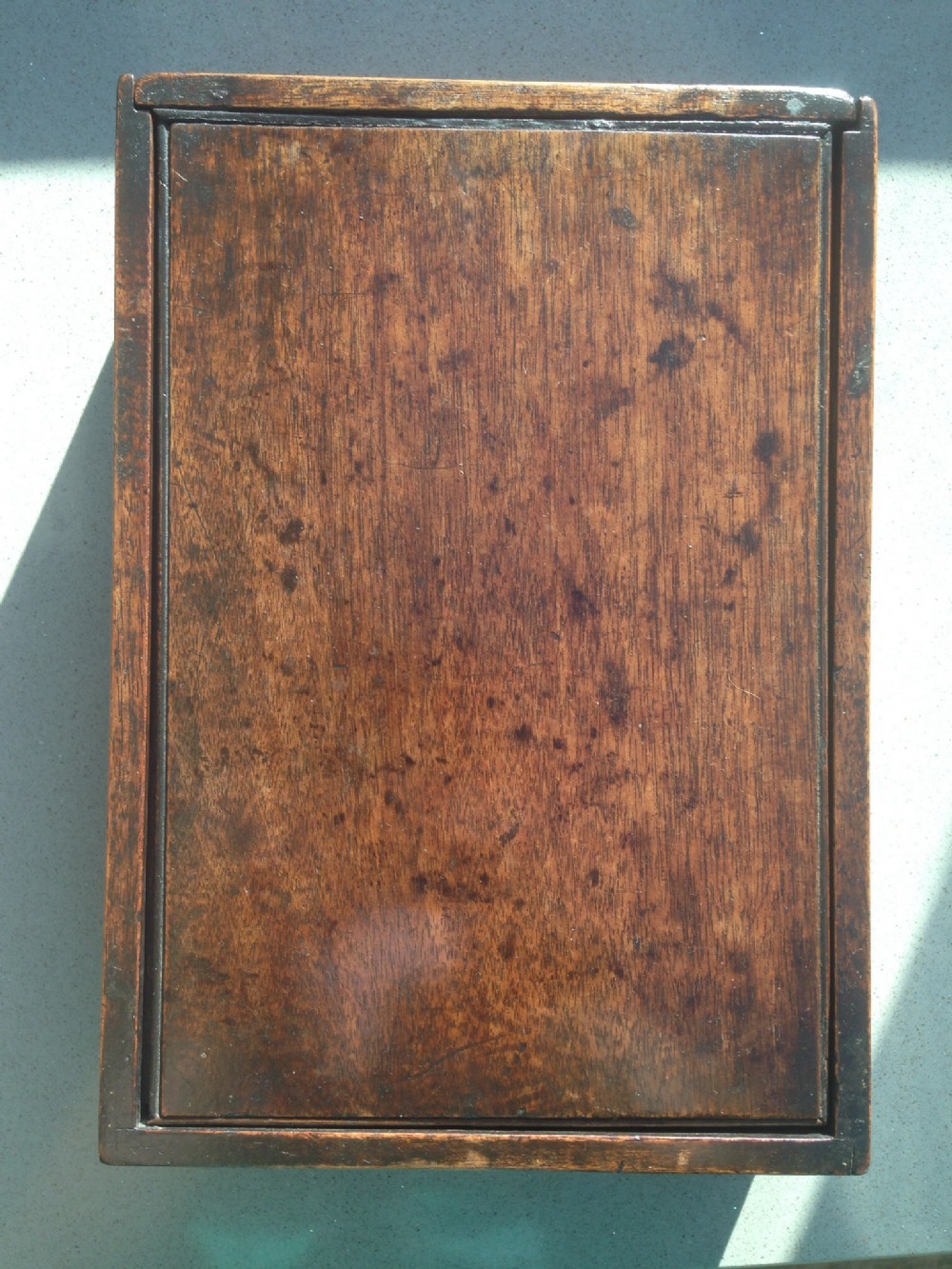 A mahogany table box with sliding lid