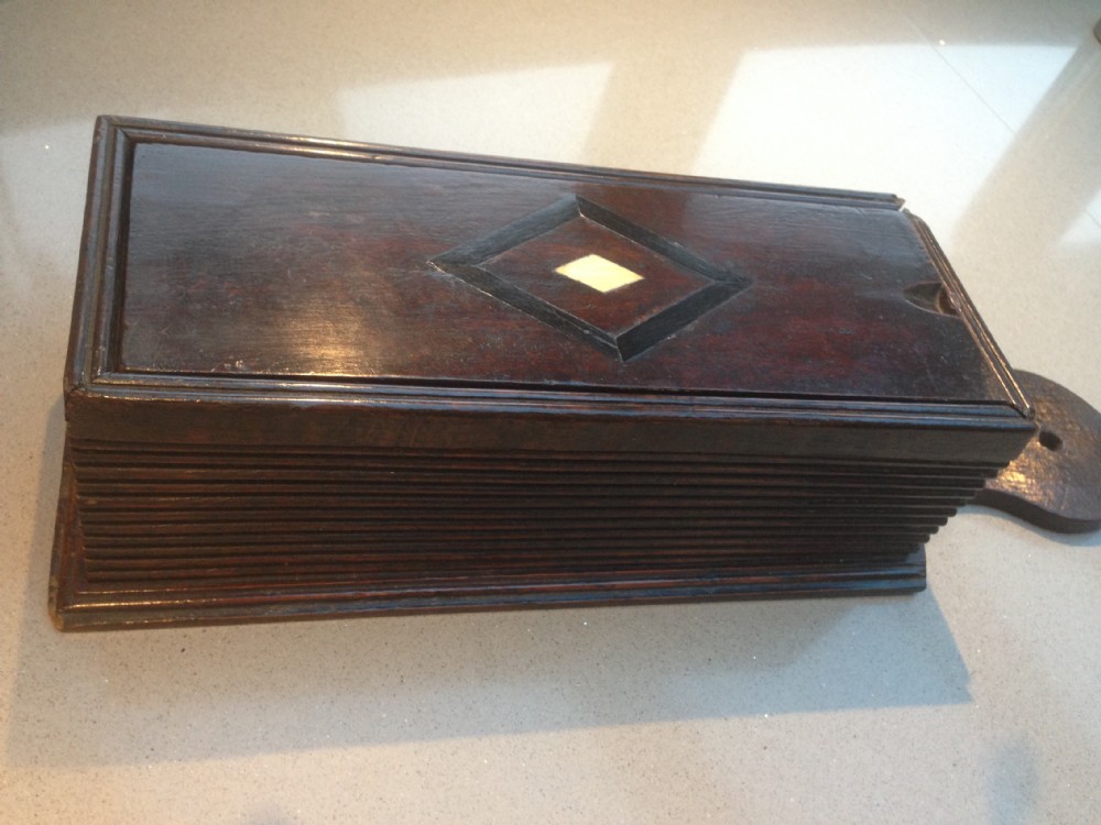 A late 18th century oak candle box